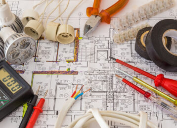 Still Life Of Electrical Components Arranged On Plans.